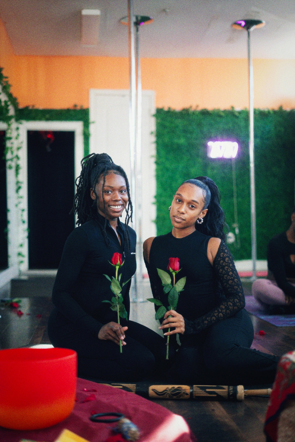 Empress Ka and Prophecy holding roses before the sound bath