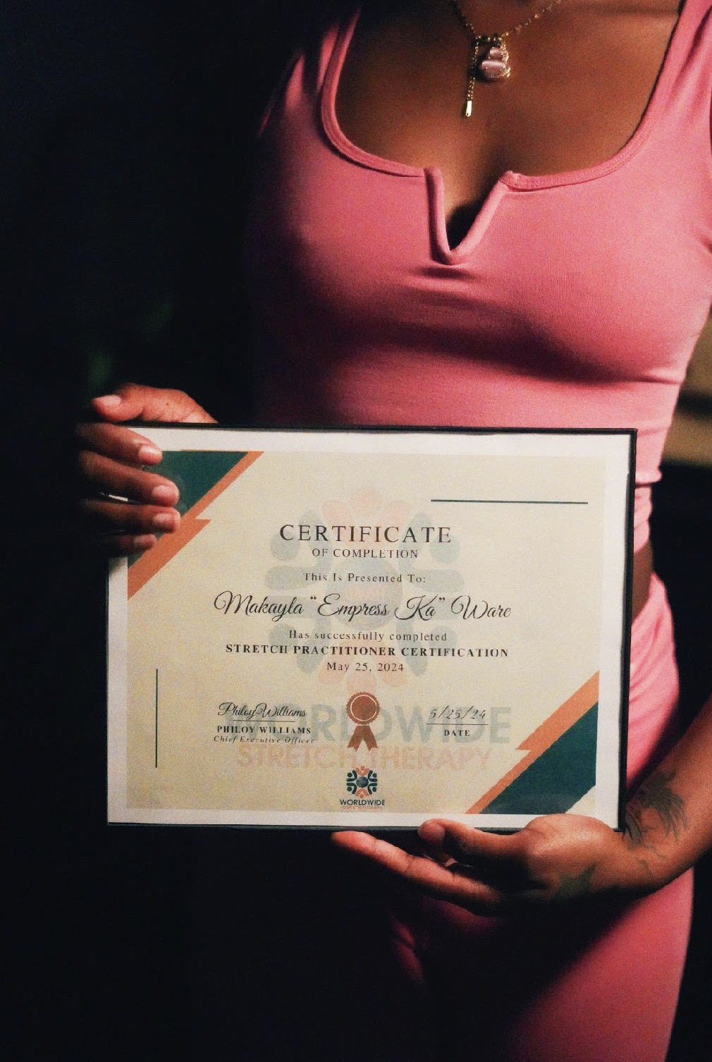 Empress Ka holding her Stretch Practitioner Certification