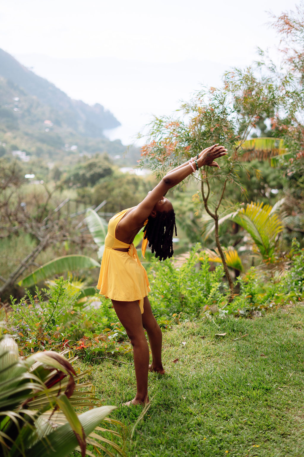 Empress in a standing backbend surrounded by tropical greenery, Guatemala